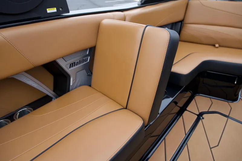 Slide: The Image of 2020 Malibu Wakesetter 24 MXZ interior with tan leather seating and sleek design. - 17