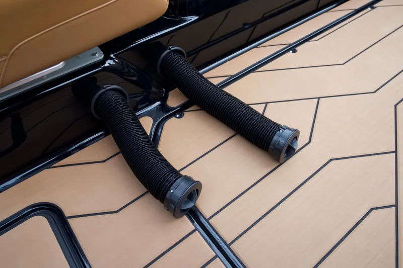 Slide: The Image of 2020 Malibu Wakesetter 24 MXZ boat deck with black hoses and tan flooring. - 19