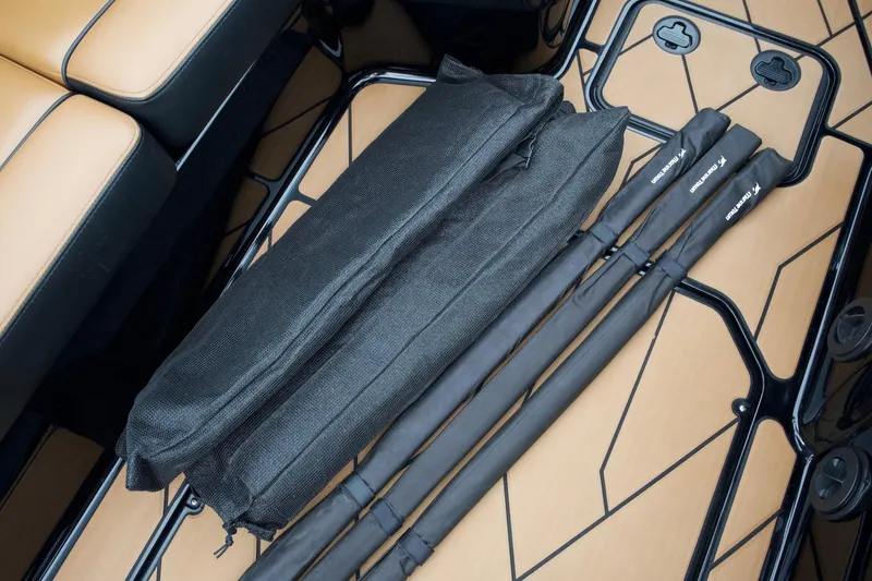 Slide: The Image of 2020 Malibu Wakesetter 24 MXZ interior with black accessories on tan flooring. - 21