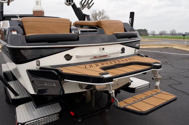 Slide: The Image of 2020 Malibu Wakesetter 24 MXZ boat with tan seating and swim platform. - 5