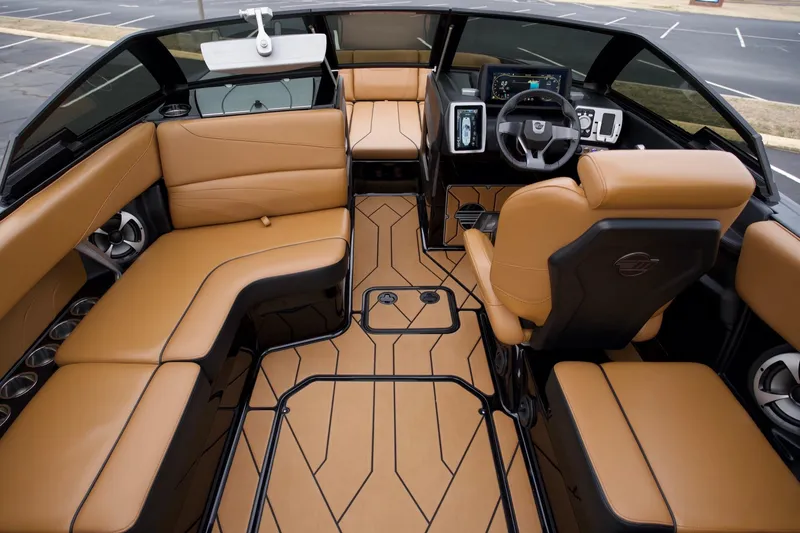 Slide: The Image of Luxurious interior of 2020 Malibu Wakesetter 24 MXZ boat with tan seating and modern dashboard. - 8