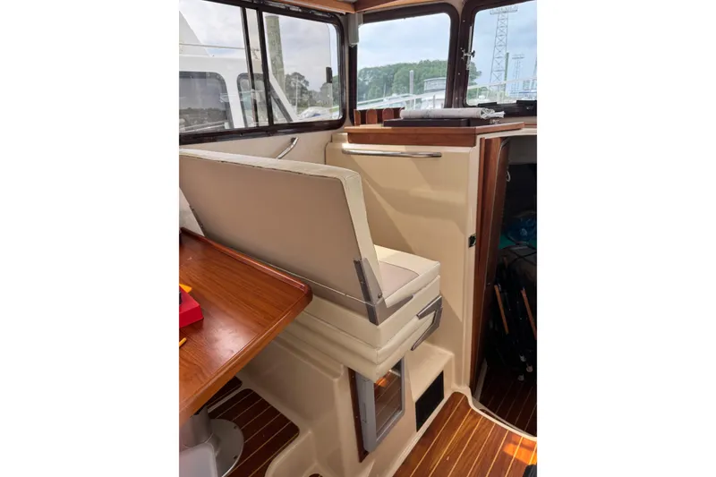 Slide: The Image of 2009 Ranger Tugs R-29 interior with seating and wooden accents. - 15