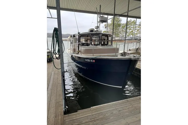 Slide: The Image of 2009 Ranger Tugs R-29 docked in a covered marina, front view. - 8