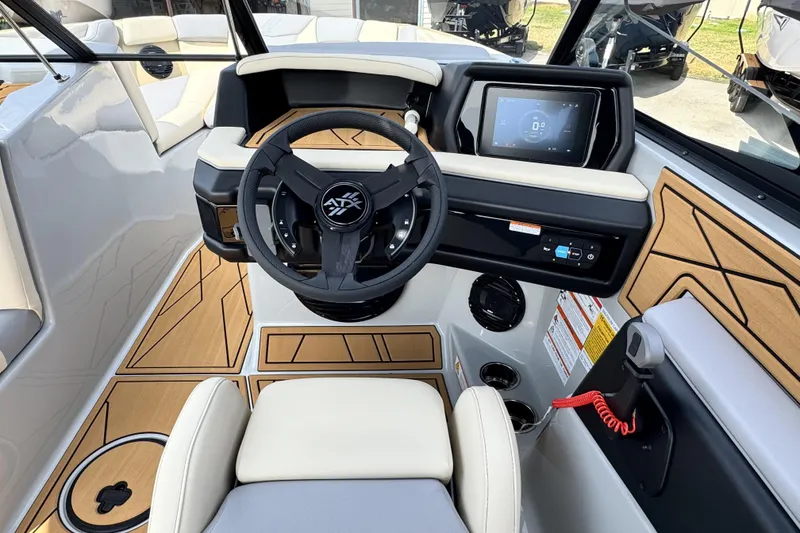 Slide: The Image of 2026 ATX Surf Boats 22 Type-S cockpit with modern steering and digital display. - 11
