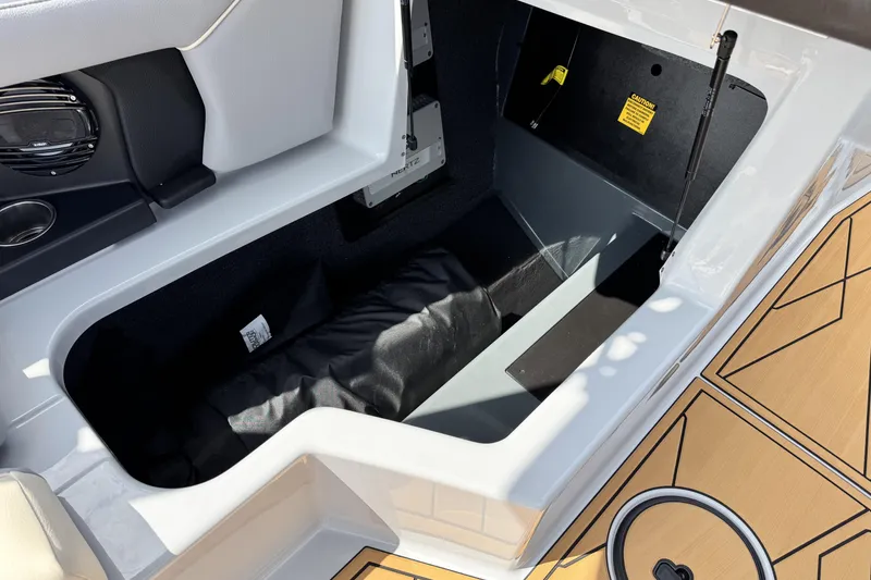 Slide: The Image of 2026 ATX Surf Boats 22 Type-S storage compartment with speaker and cushioned interior. - 16