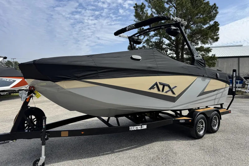 Slide: The Image of 2026 ATX Surf Boats 22 Type-S on trailer, covered, in outdoor setting. - 20