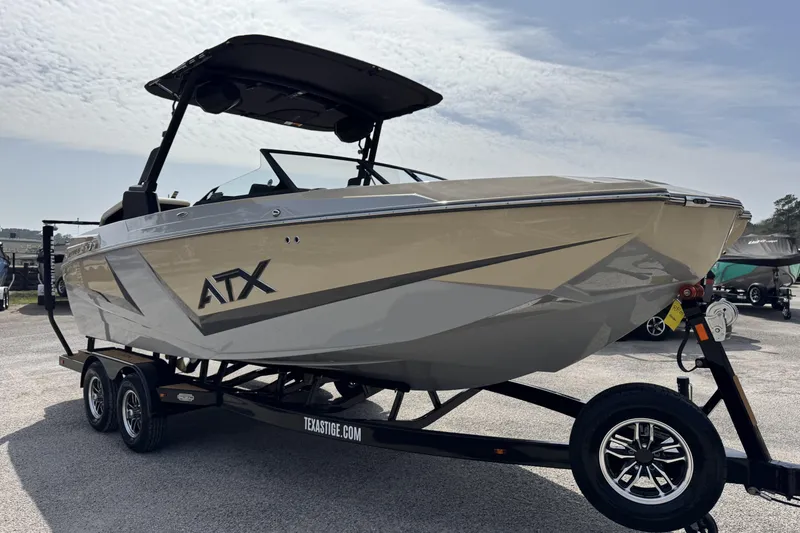 Slide: The Image of 2026 ATX Surf Boats 22 Type-S on trailer, sleek design under cloudy sky. - 7