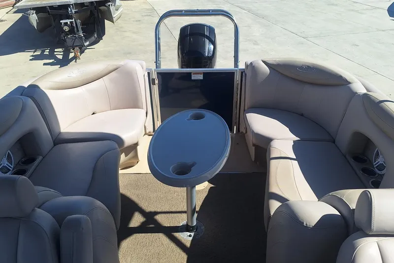 Slide: The Image of 2013 Sylvan Mirage Cruise 8522 LZ pontoon boat interior with beige seating and table. - 6