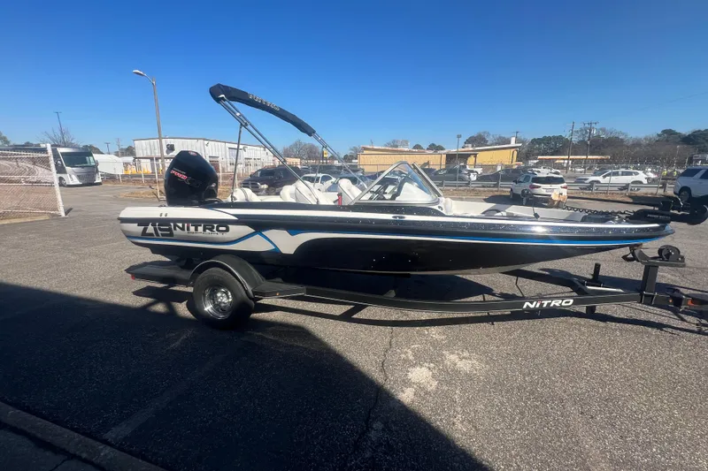 Slide: The Image of 2022 Nitro Z19 Sport boat on trailer in parking lot, sunny day. - 13
