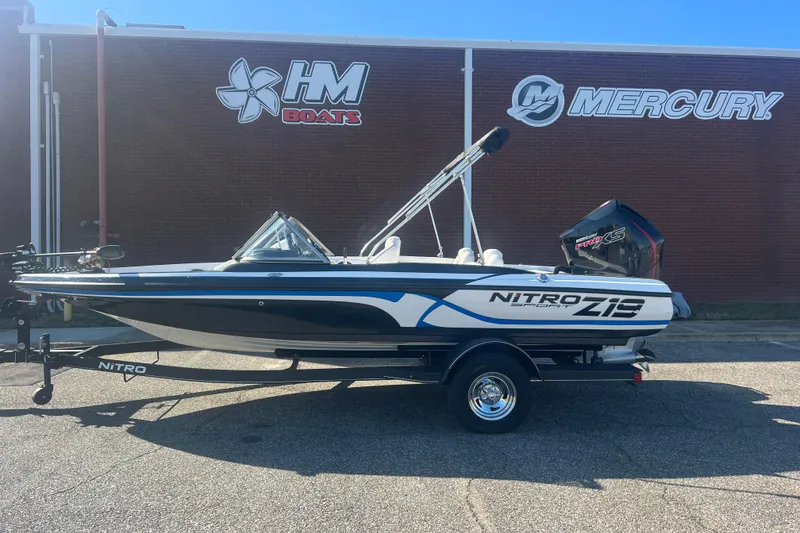 Slide: The Image of 2022 Nitro Z19 Sport boat on trailer, parked outside HM Boats and Mercury building. - 2