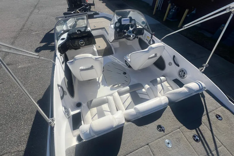 Slide: The Image of 2022 Nitro Z19 Sport boat interior with white seating and steering console. - 22