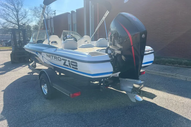 Slide: The Image of 2022 Nitro Z19 Sport boat on trailer, parked outdoors in sunlight. - 5