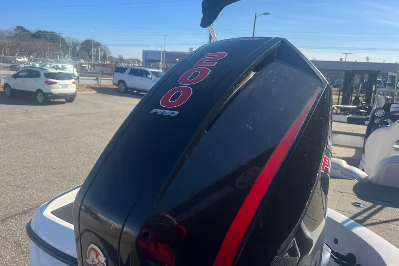 Slide: The Image of 2022 Nitro Z19 Sport boat with a 200 Pro outboard motor in a parking lot. - 6