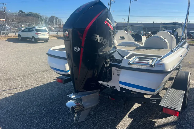 Slide: The Image of 2022 Nitro Z19 Sport boat with powerful outboard motor in a parking lot. - 7