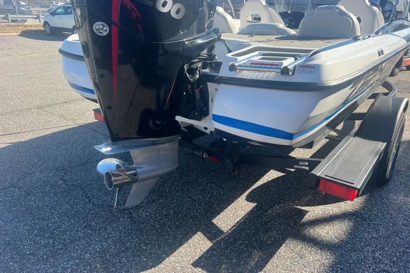 Slide: The Image of 2022 Nitro Z19 Sport boat on trailer, featuring powerful outboard motor. - 8