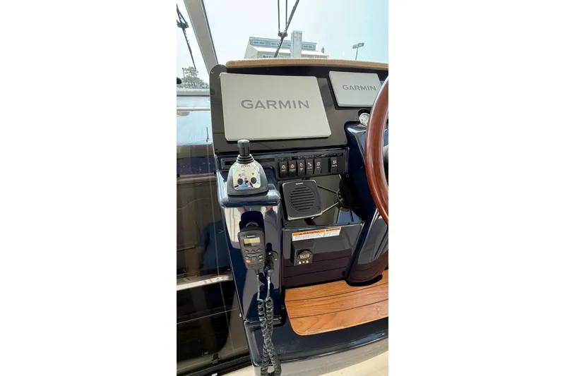 Slide: The Image of 2007 Tiara Yachts 3900 Sovran helm with Garmin navigation displays and controls. - 17