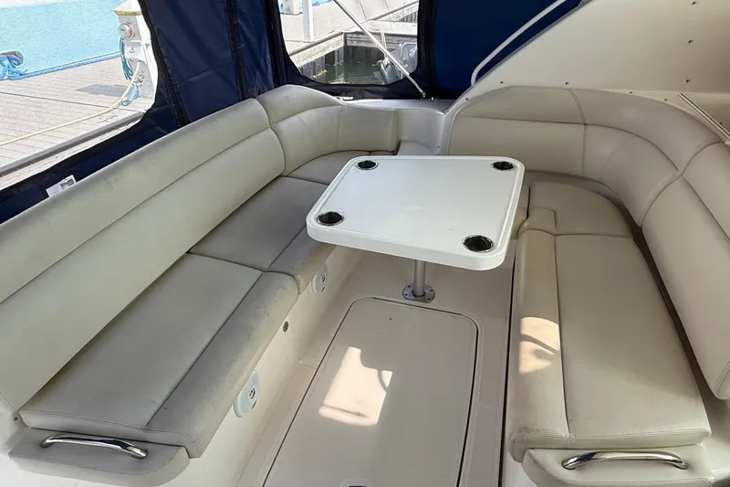 Slide: The Image of 2007 Tiara Yachts 3900 Sovran interior with beige seating and a central table. - 28
