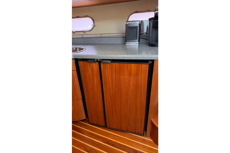 Slide: The Image of 2007 Tiara Yachts 3900 Sovran interior with wooden cabinets and modern appliances. - 40