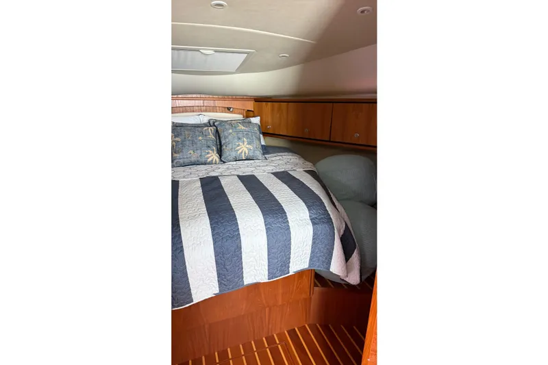 Slide: The Image of Cozy cabin interior of 2007 Tiara Yachts 3900 Sovran with striped bedding. - 44