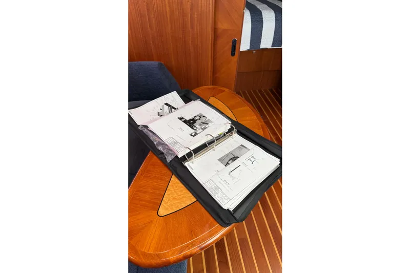 Slide: The Image of Open binder with yacht schematics on a wooden table, Tiara Yachts 3900 Sovran, 2007 model. - 46