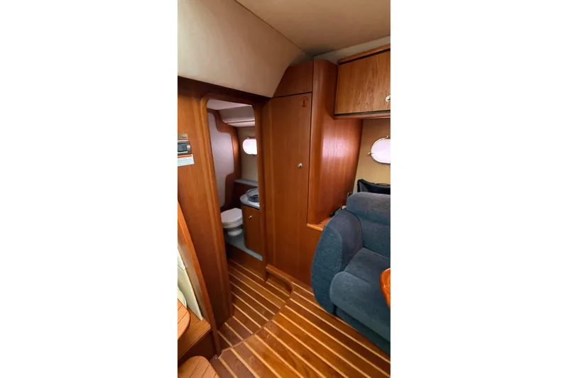 Slide: The Image of 2007 Tiara Yachts 3900 Sovran interior with wooden flooring and compact bathroom. - 49