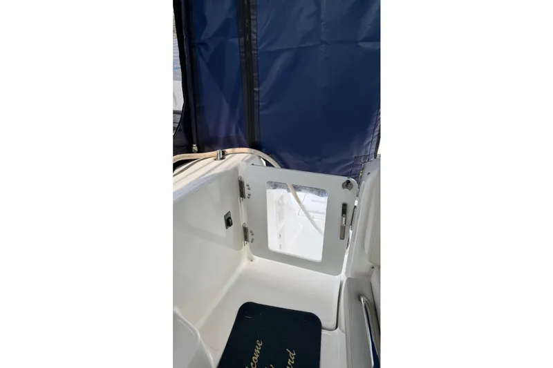 Slide: The Image of 2007 Tiara Yachts 3900 Sovran cockpit with blue canopy and open door. - 5