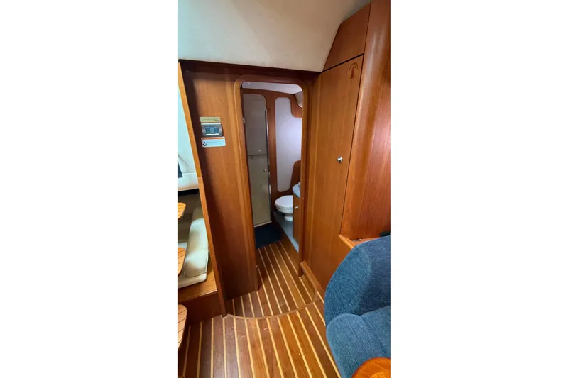 Slide: The Image of 2007 Tiara Yachts 3900 Sovran interior with wooden flooring and compact bathroom. - 50