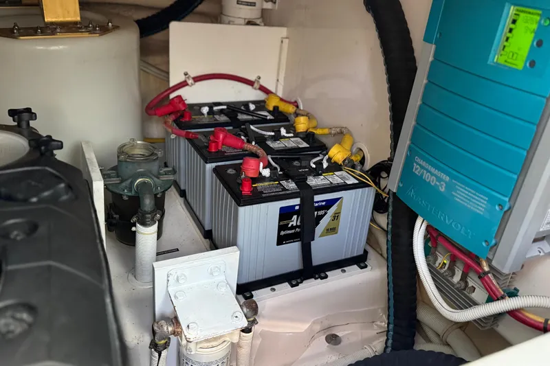 Slide: The Image of Engine compartment of a 2007 Tiara Yachts 3900 Sovran, featuring batteries and a Mastervolt charger. - 58