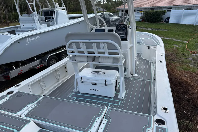Slide: The Image of 2019 Sea Fox 240 Viper boat with modern deck and seating, parked outdoors. - 11