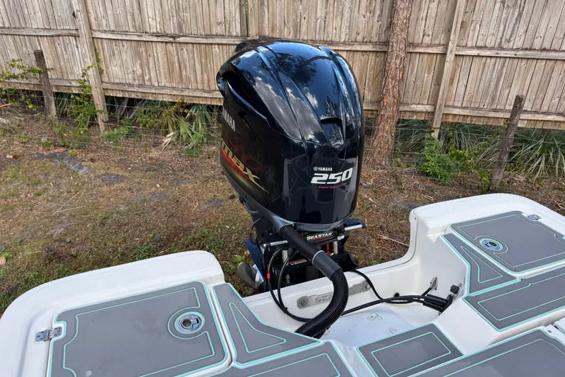 Slide: The Image of 2019 Sea Fox 240 Viper boat with Yamaha 250 engine, parked near wooden fence. - 13