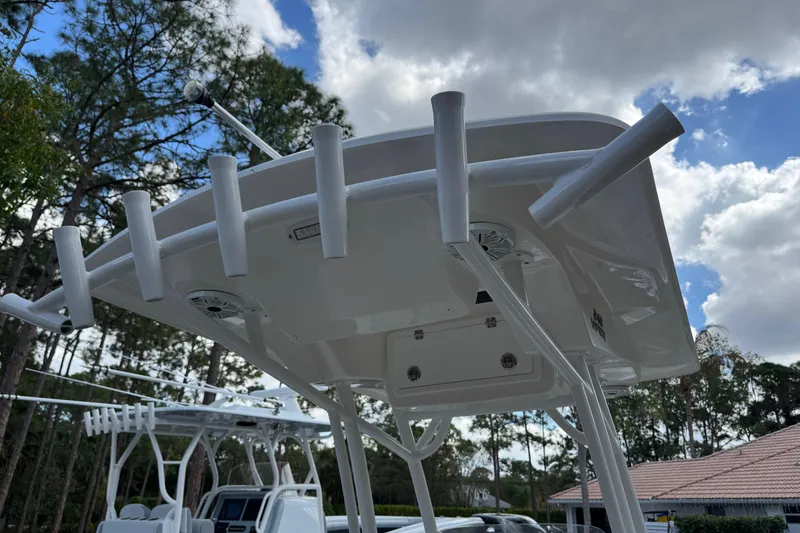 Slide: The Image of 2019 Sea Fox 240 Viper boat with rod holders and canopy, set against a cloudy sky. - 18