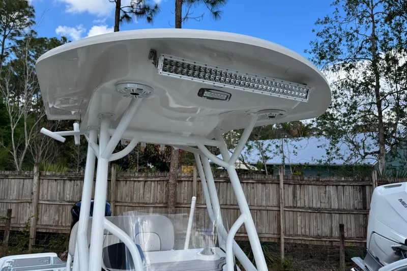 Slide: The Image of 2019 Sea Fox 240 Viper T-top with LED light bar and speakers, outdoor setting. - 20