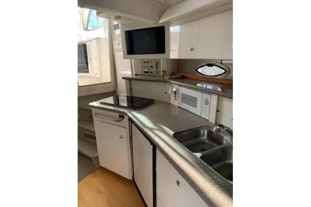 Slide: The Image of 2000 Maxum 3300 SCR yacht kitchen with modern appliances and sleek countertops. - 13