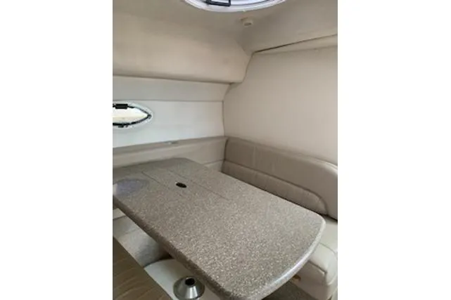 Slide: The Image of Interior of 2000 Maxum 3300 SCR boat with beige seating and table. - 14