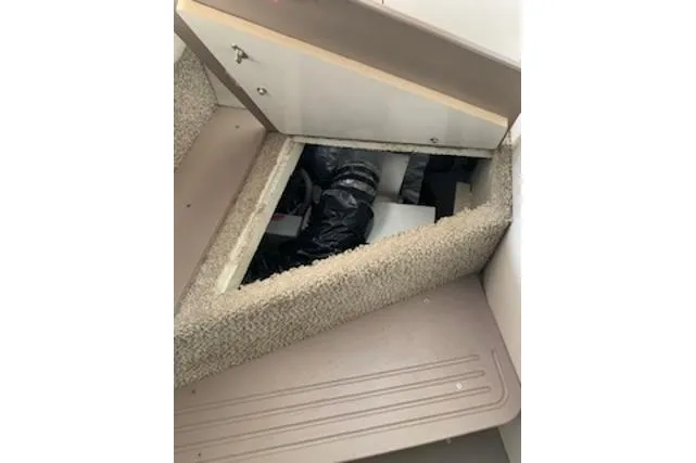 Slide: The Image of Access hatch in 2000 Maxum 3300 SCR boat interior, revealing storage or mechanical area. - 15