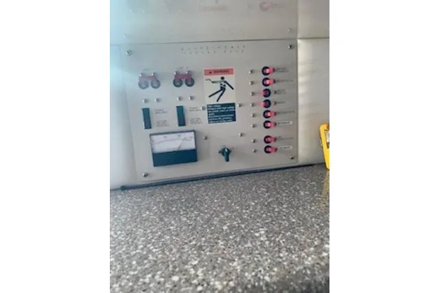 Slide: The Image of Electrical control panel on 2000 Maxum 3300 SCR boat, featuring switches and warning labels. - 16