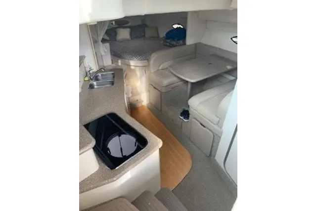 Slide: The Image of 2000 Maxum 3300 SCR yacht interior with kitchenette, seating, and sleeping area. - 18