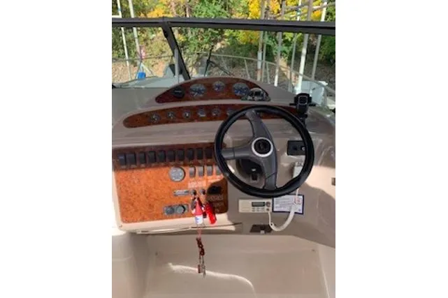 Slide: The Image of Cockpit of 2000 Maxum 3300 SCR boat with steering wheel and control panel. - 20