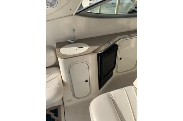 Slide: The Image of 2000 Maxum 3300 SCR boat interior with sink and storage cabinets. - 21
