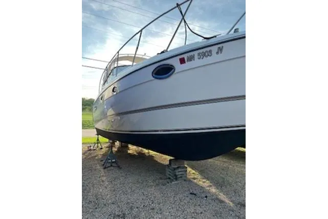 Slide: The Image of 2000 Maxum 3300 SCR boat on stands, side view, outdoors. - 27