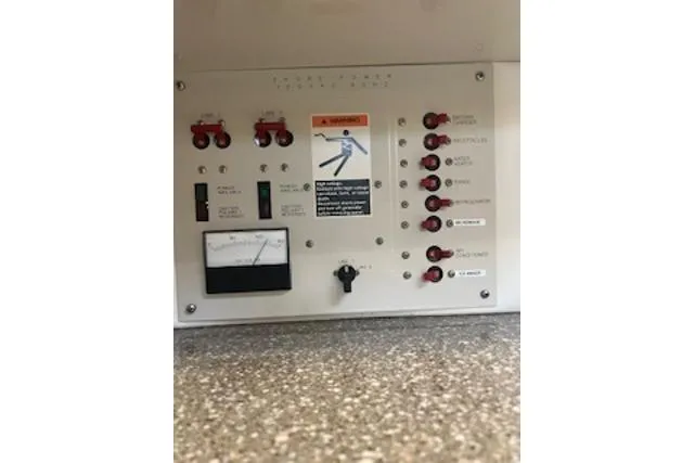 Slide: The Image of Control panel of a 2000 Maxum 3300 SCR boat, featuring switches and a meter. - 28