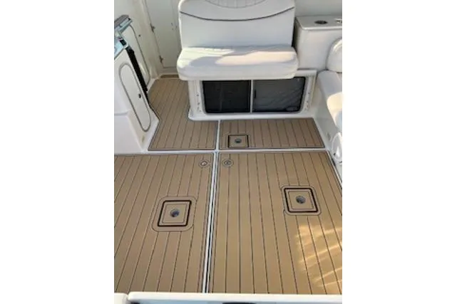 Slide: The Image of 2000 Maxum 3300 SCR boat interior with teak flooring and cushioned seating. - 30