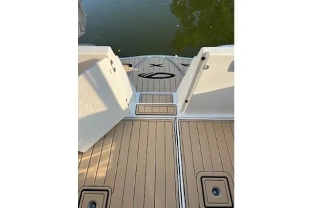 Slide: The Image of 2000 Maxum 3300 SCR boat deck with wood finish, overlooking calm water. - 31