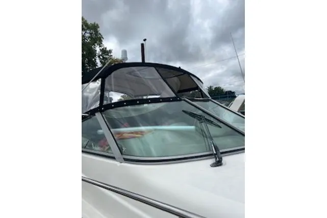 Slide: The Image of 2000 Maxum 3300 SCR boat with canopy under cloudy sky. - 36