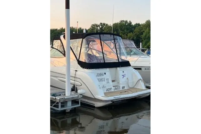 Slide: The Image of 2000 Maxum 3300 SCR boat docked at marina, rear view with canopy. - 38