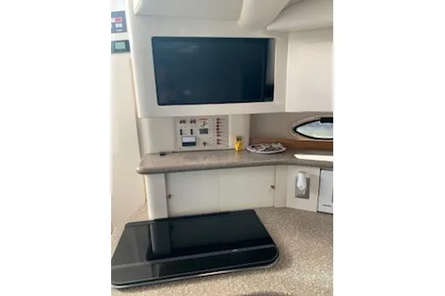 Slide: The Image of Interior of 2000 Maxum 3300 SCR yacht with modern control panel and TV. - 5