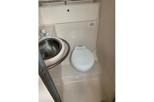 Slide: The Image of Compact bathroom in 2000 Maxum 3300 SCR boat with sink and toilet. - 8