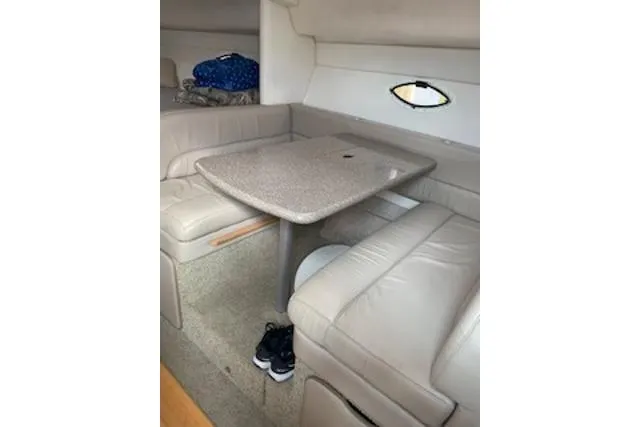 Slide: The Image of Interior of 2000 Maxum 3300 SCR boat with beige seating and table. - 9