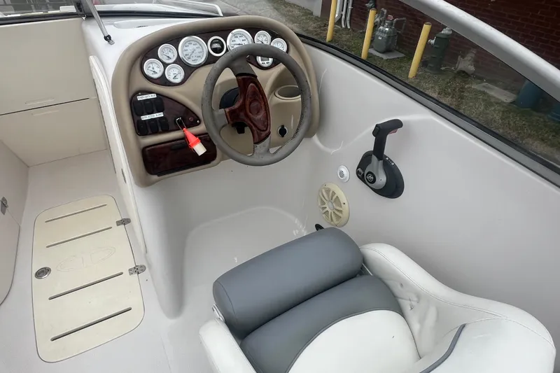 Slide: The Image of Interior of a 2005 Tahoe 234 boat showing steering wheel and control panel. - 13