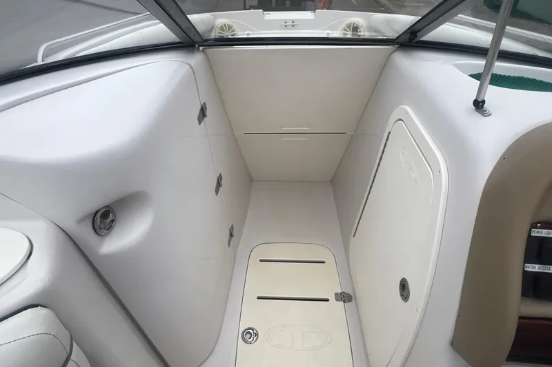Slide: The Image of Interior of a 2005 Tahoe 234 boat, featuring storage compartments and sleek design. - 14